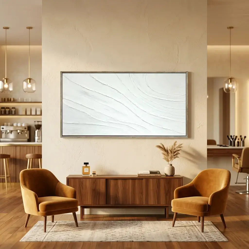 Modern living room with two brown armchairs, a wooden cabinet, and a large framed abstract painting.