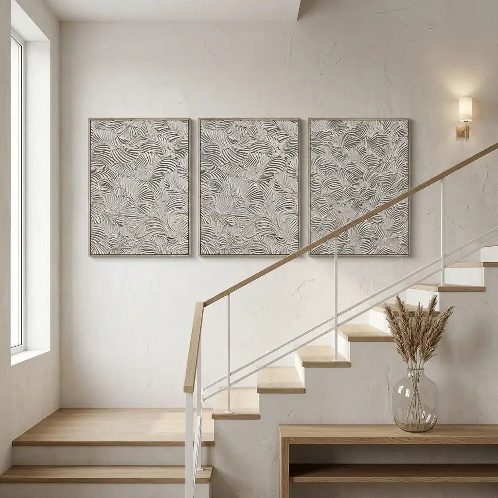 Staircase with wall art and a vase with dried flowers in a modern interior setting.