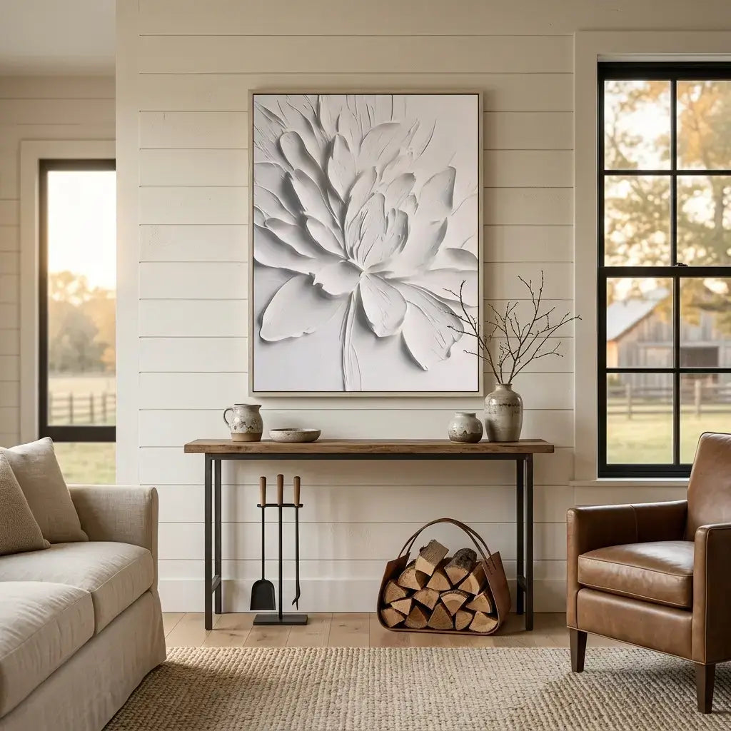 Living room with a floral wall art piece, sofa, armchair, and fireplace tools.