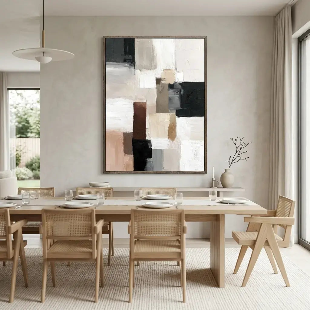 Dining room with wooden table and chairs, abstract art on the wall.