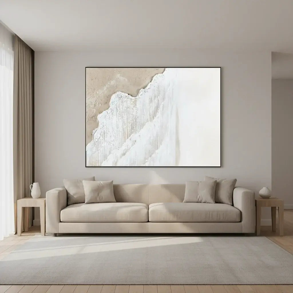 Beige sofa in a living room with a large abstract painting on the wall.