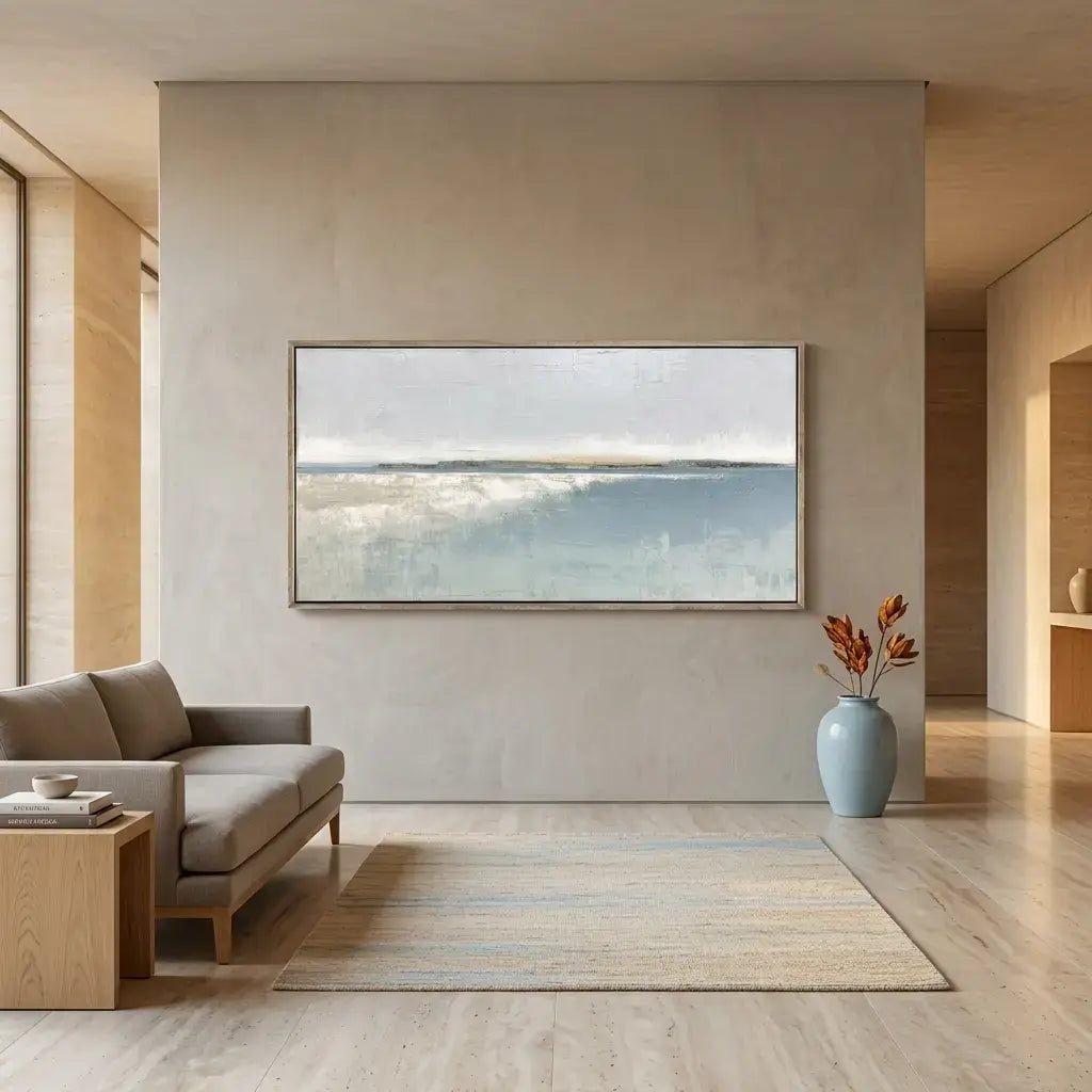 Modern living room with a large framed artwork on the wall, a sofa, and a vase.
