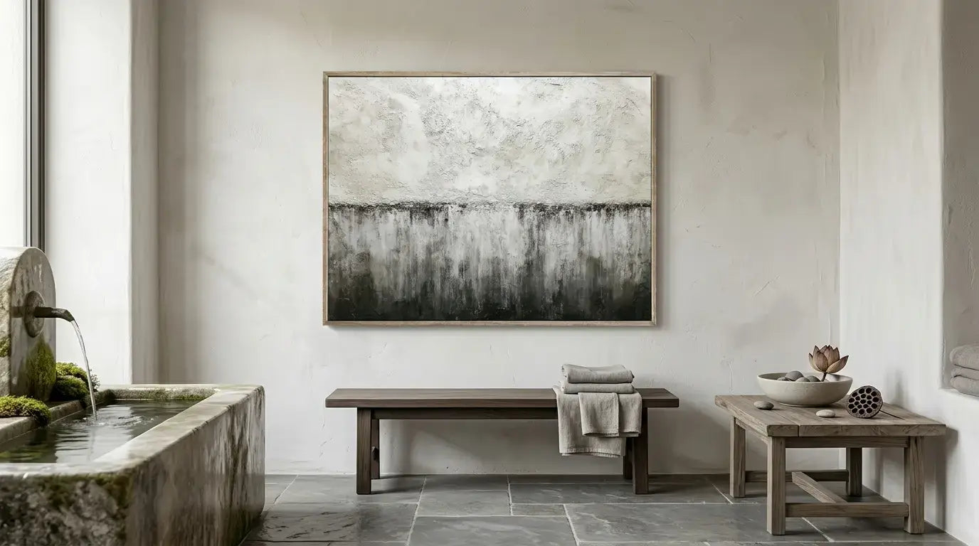 Modern bathroom interior with abstract art on the wall, stone sink, and wooden bench.