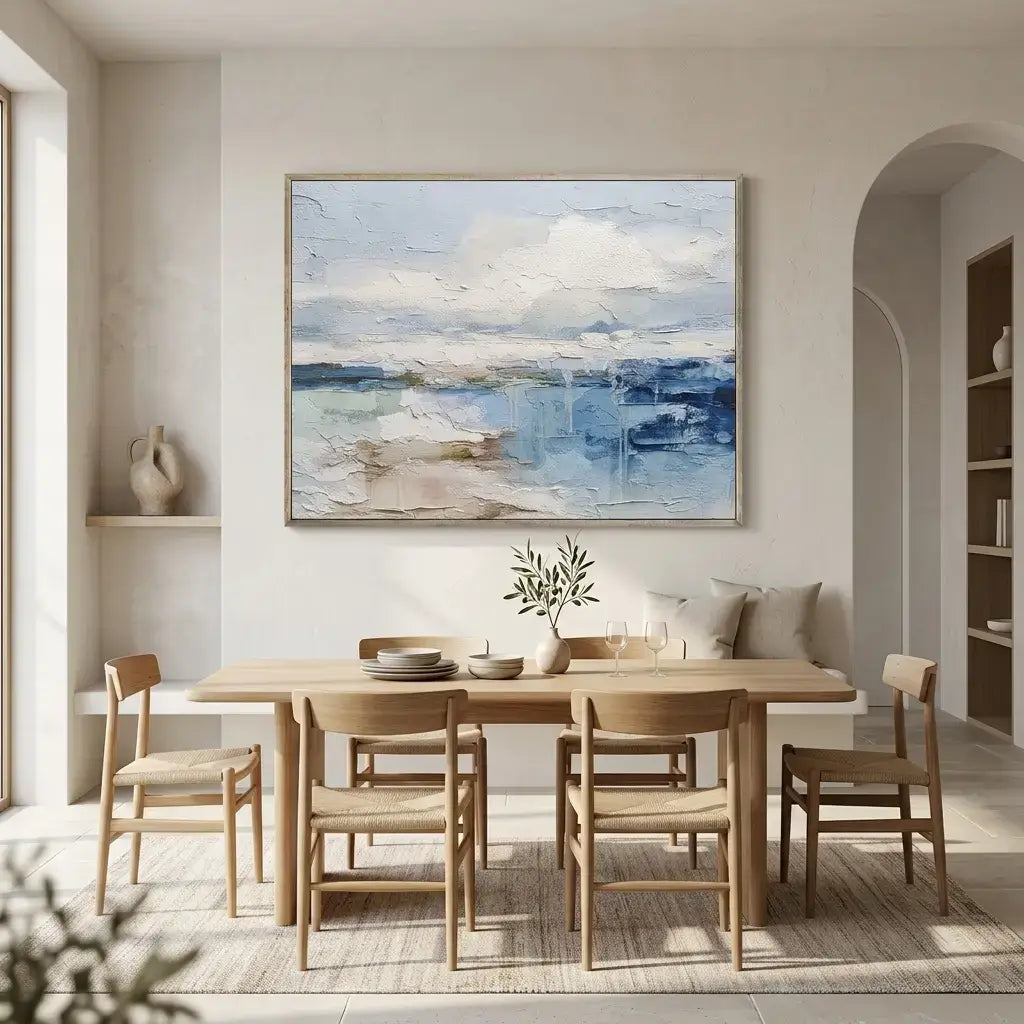 Dining room with wooden table and chairs, abstract painting on the wall, and a vase on a shelf.