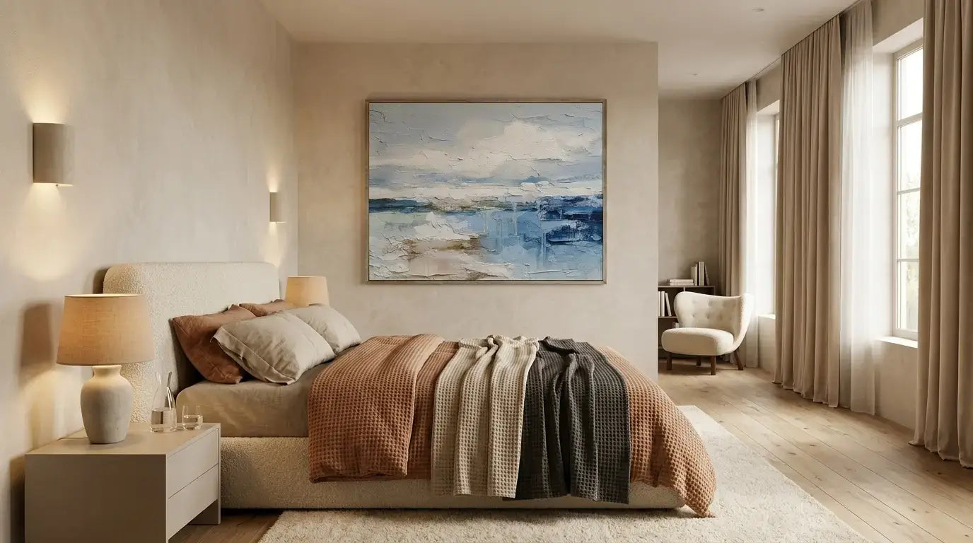 Modern bedroom with a bed, lamp, and wall art