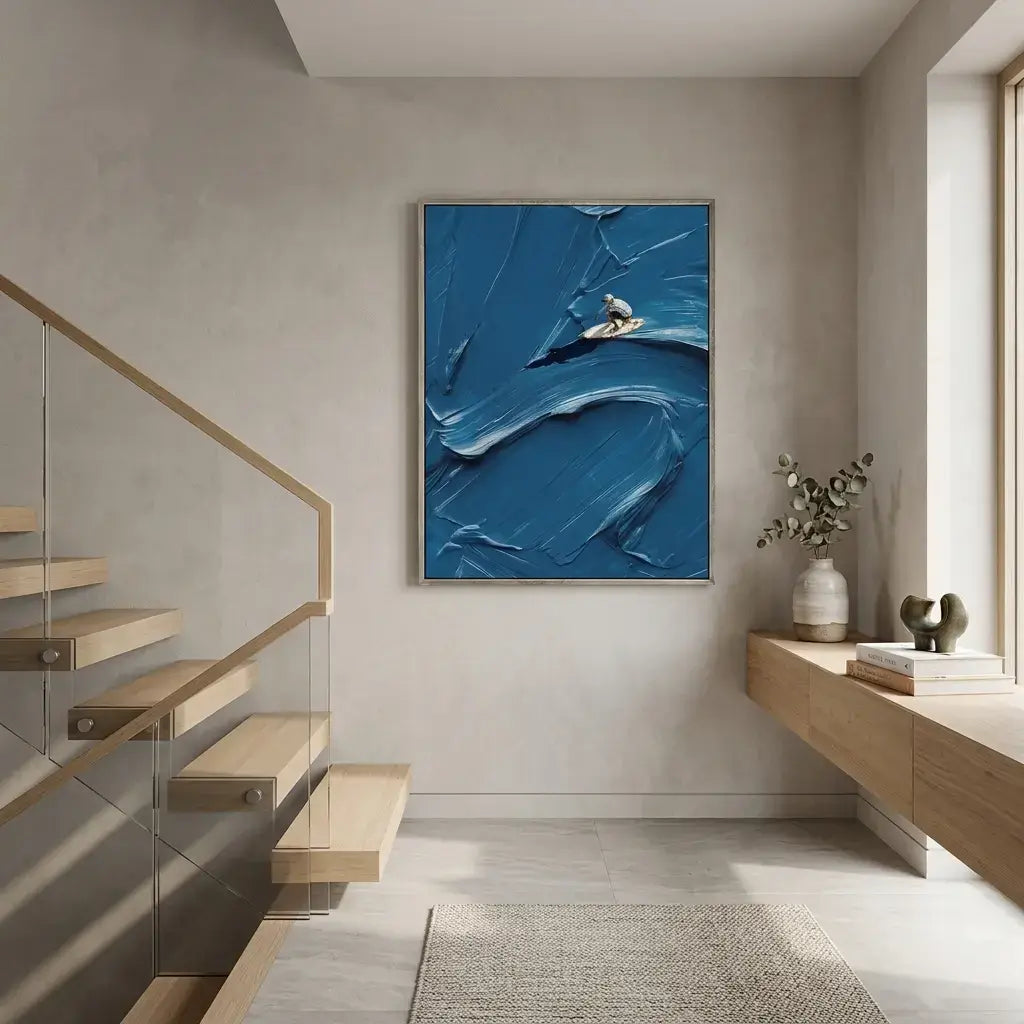 Modern interior with abstract blue artwork on a wall, wooden staircase, and desk.