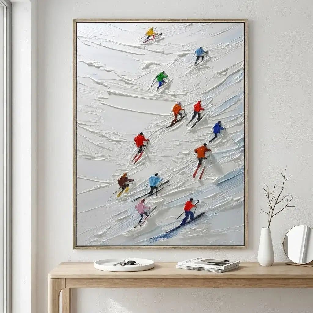 Framed artwork of skiers on a snowy slope above a wooden console table.