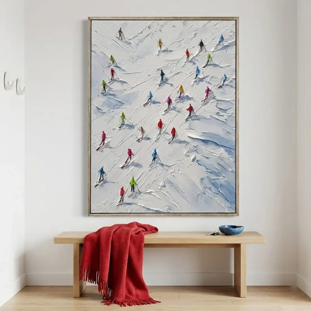 Abstract painting of skiers on a snowy landscape above a wooden bench with a red blanket.