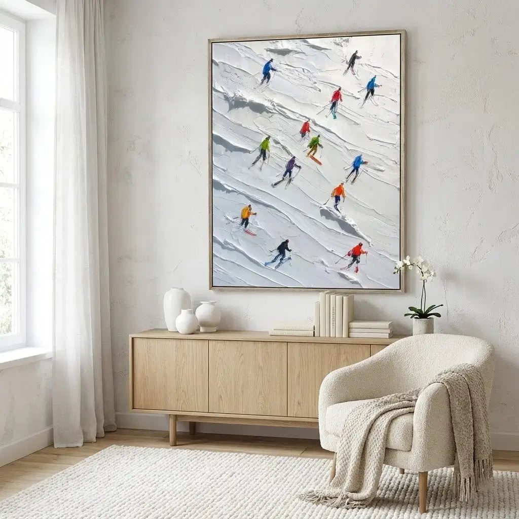 Modern living room with a large framed artwork of skiers on a wall above a wooden cabinet.
