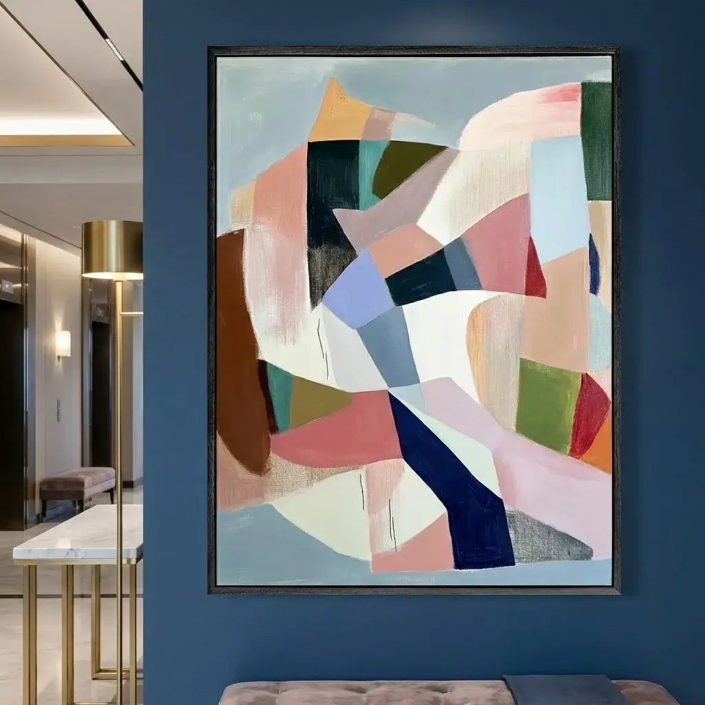 Abstract art piece on a blue wall in a modern interior setting