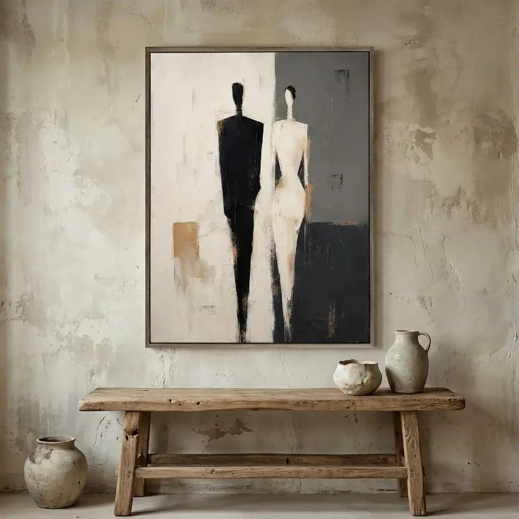 Abstract art of two figures on a textured wall above a wooden bench with decorative vases.