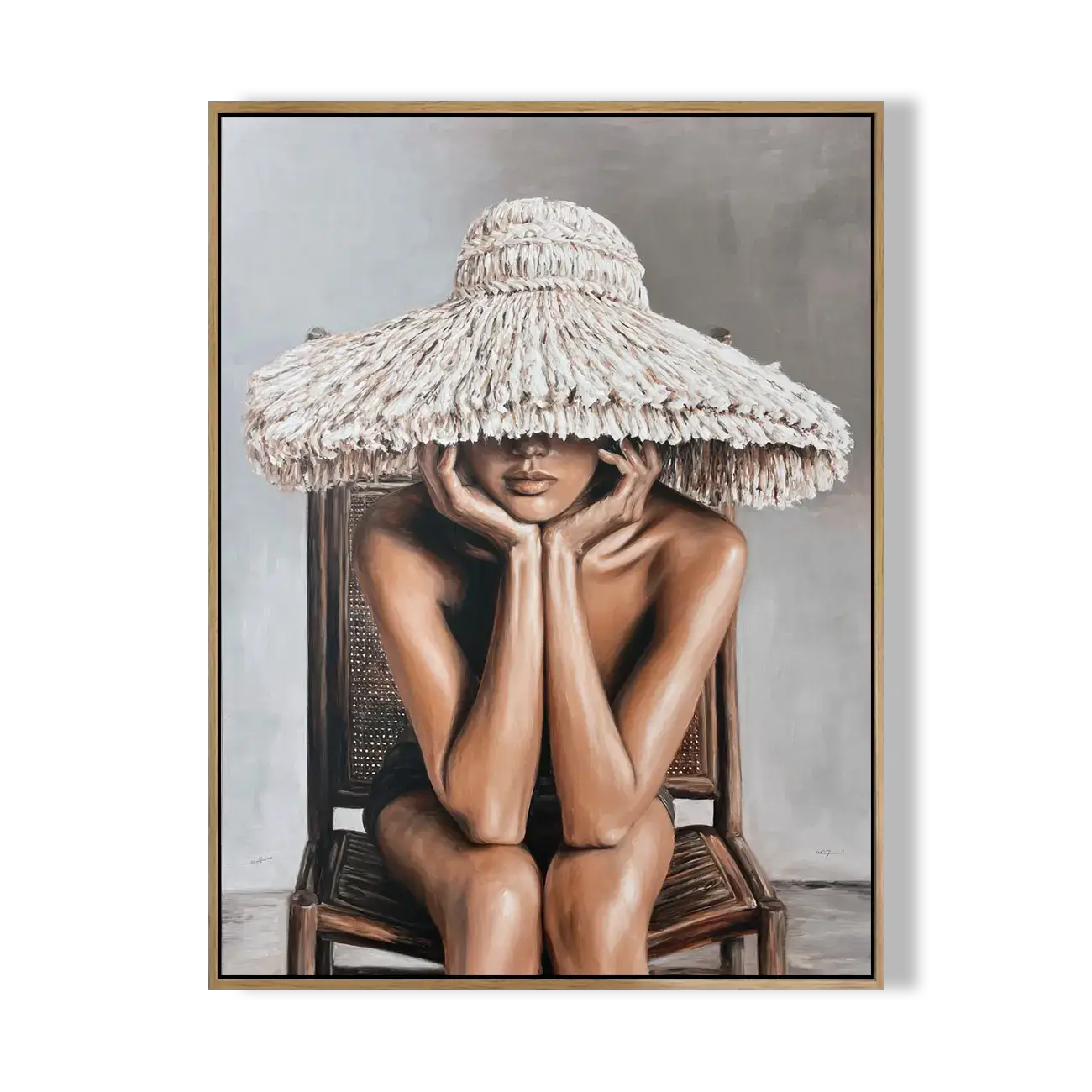 Framed artwork of a person wearing a large straw hat sitting on a chair.